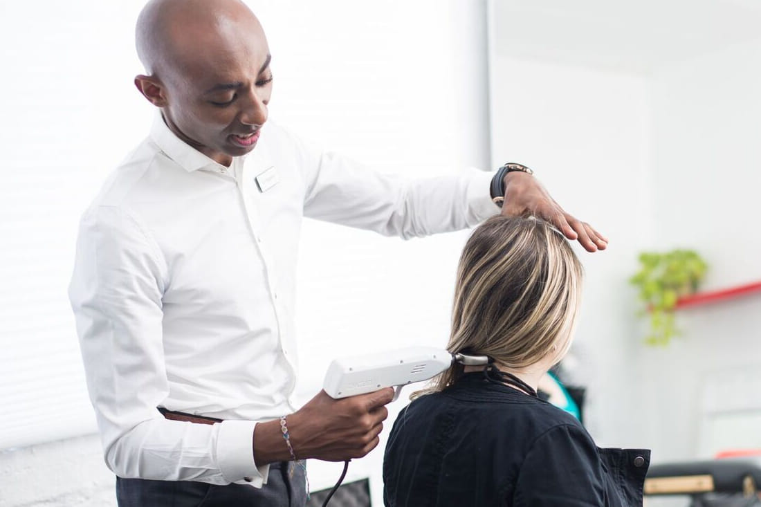 Dr. Daniel treating a patient's neck during a visit at Alem Integrated Health